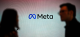 Silhouetted speakers flank a screen showing the Meta logo, suggesting a presentation or panel.