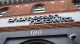 Brick storefront facade with a large 'andreessen horowitz' sign and the number 180 below; security camera on the right.