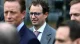 Will AI Pay Off? The Technology Is Real. The Timeline Is What's in Question. 2 A businessman wearing glasses standing among a crowd of other executives