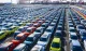 Rows of Chinese electric vehicles at a port awaiting export
