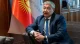 Central Asia's Fastest-Growing Economy Is About to Borrow in Yuan 2 A Kyrgyz central bank official seated near the national flag