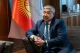 A Kyrgyz central bank official seated near the national flag